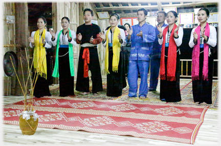 Cast of dancers in line clapping.