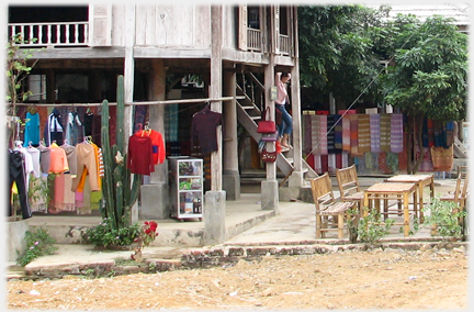 The ground floor area under a house with clothes drying.