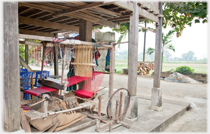 Large loom under a house overlooking fields.