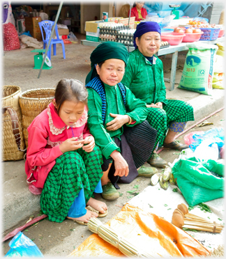 Two women and a girl in green.