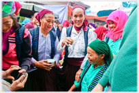 Group of women traders drinking.