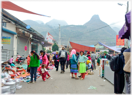 Hill beyond a street beside the market.