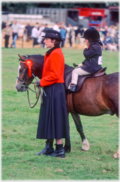 Woman, pony and girl.