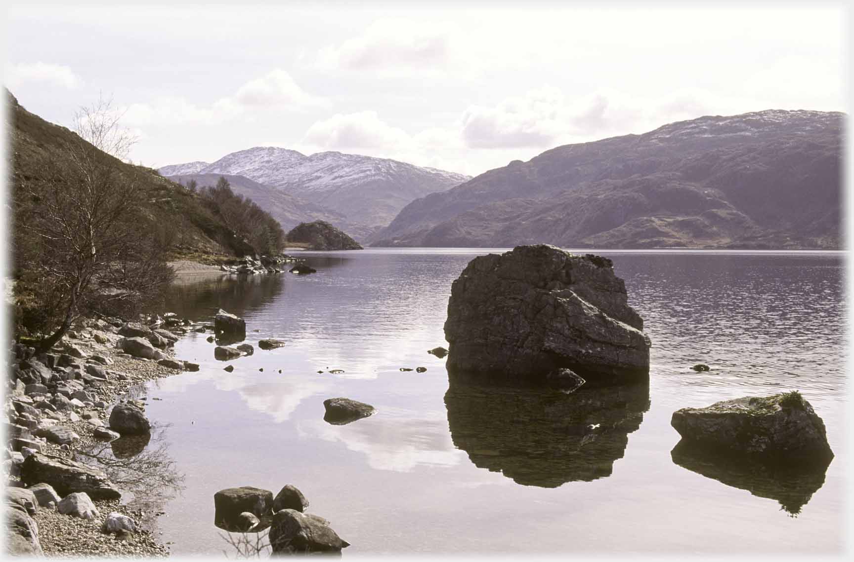 Rocks by shore of loch.