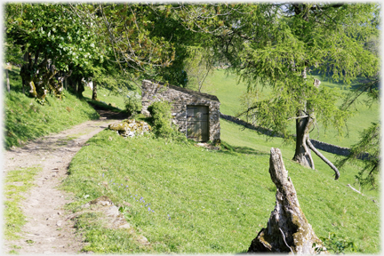 Path running past stone hut.