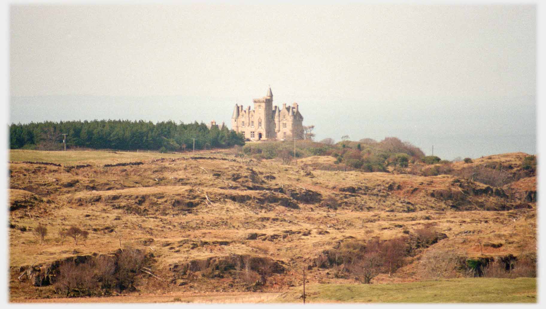 Gothic style house seen across moor.