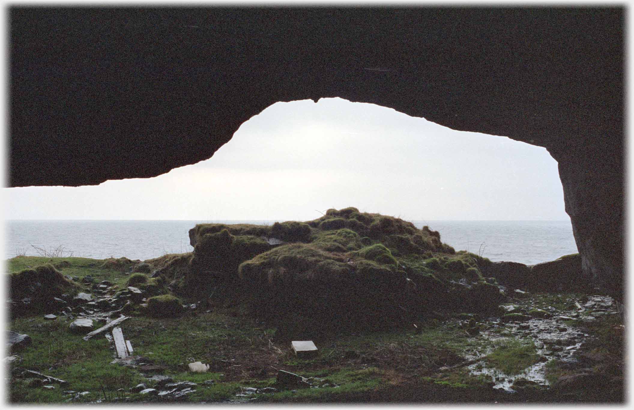 Mouth of cave with sea beyond.