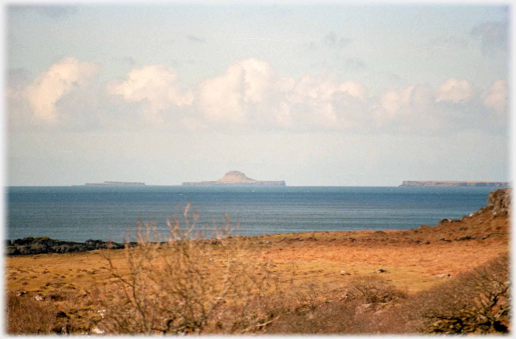 Group of islands the central one of which is shaped like a bulboous hat with brim.