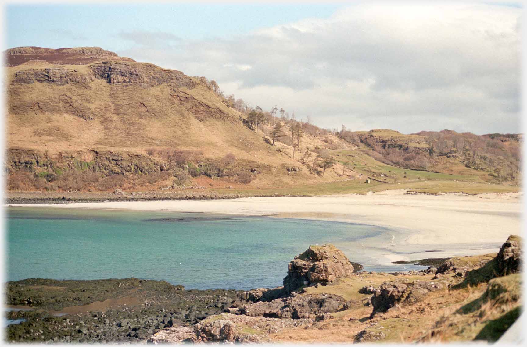 Sandy bay with turqoise water.