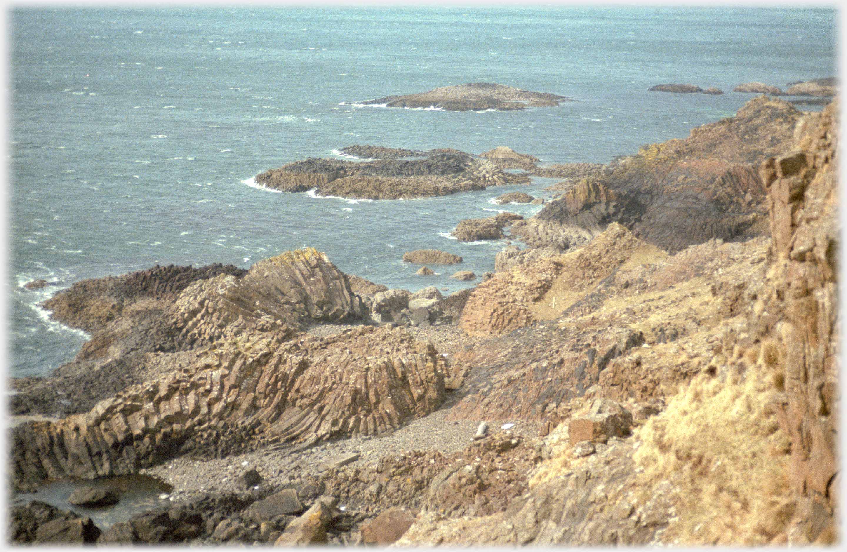 swirl of basalt columns by sea.