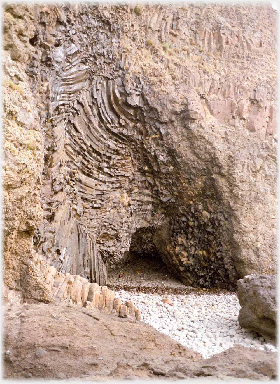 Cave entrance with tree formation in the cliff rocks.