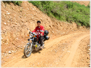 Dirt road with Han on motorbike.