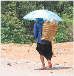 Woman with umbrella in hot sun.