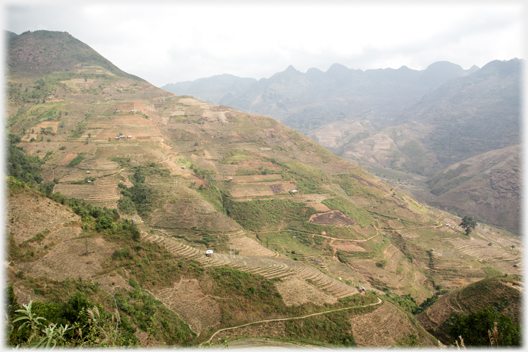 Hillside with mountains beyond.