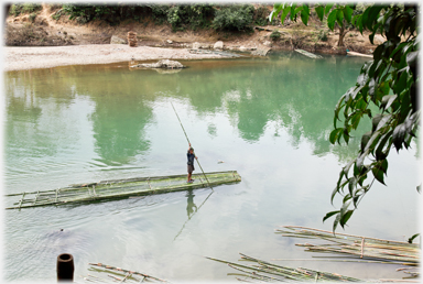 Bamboo raft being punted.