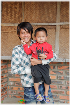 Young man holding infant.