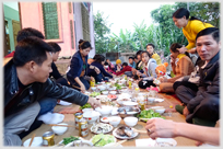 A meal on the ground at Loi's house.