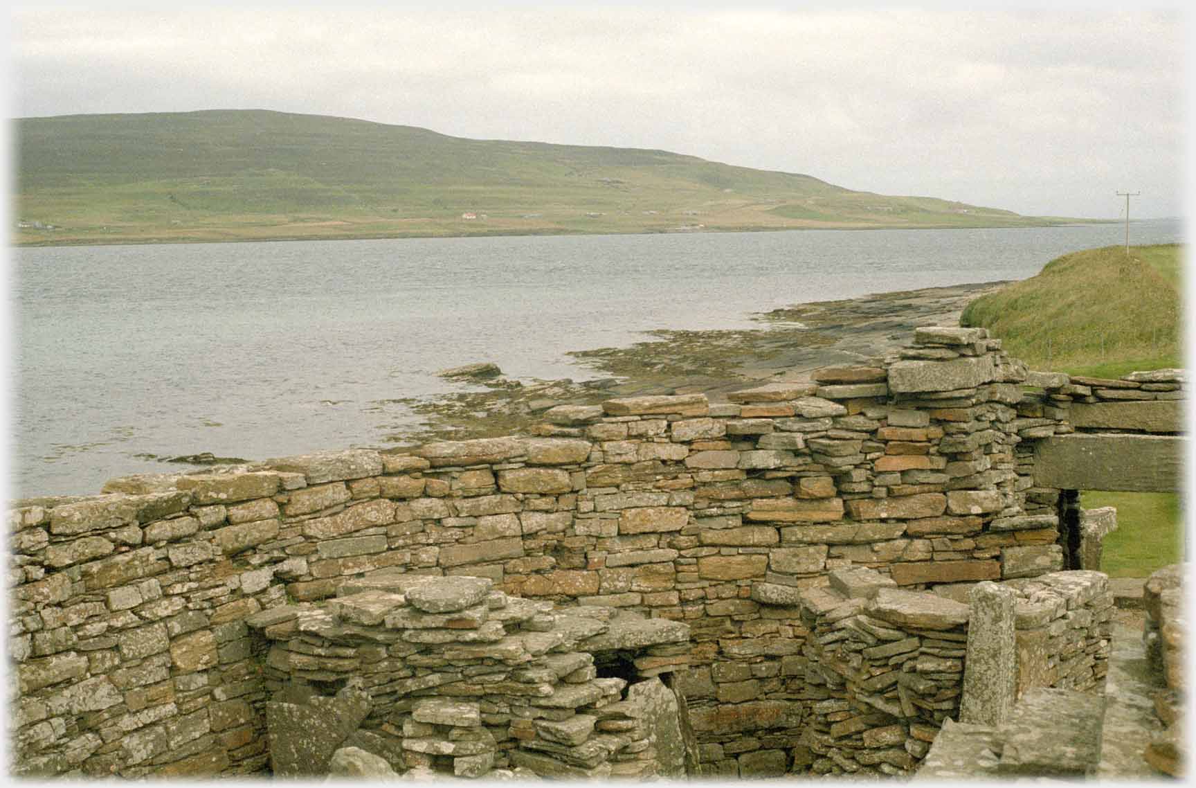 Door height inside wall with sea beyond.