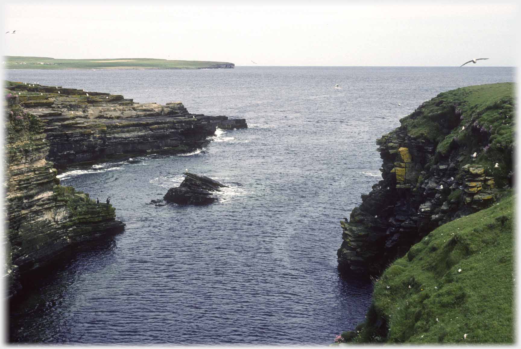 Inlet entrance with shelving at sides.