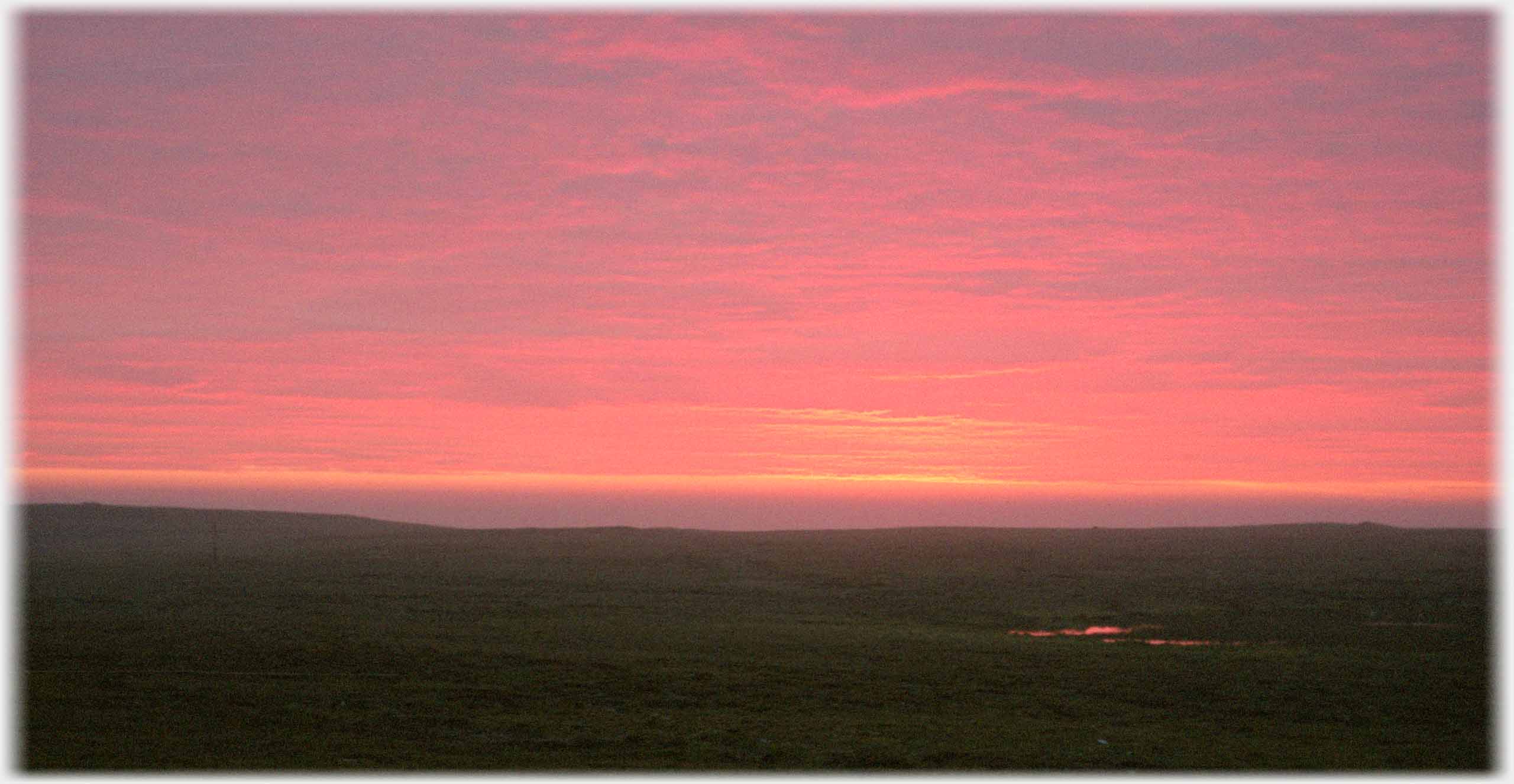 Sky clouds washed in pink.