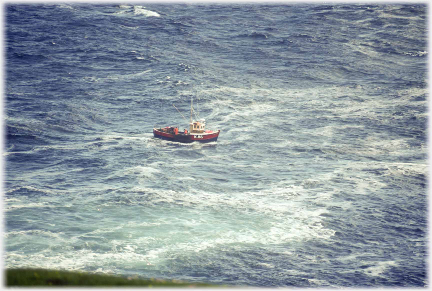 Small fishing boat in swell.