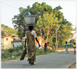 Woman with large pot on her head.