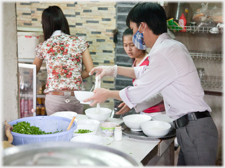 Putting pho into bowls.