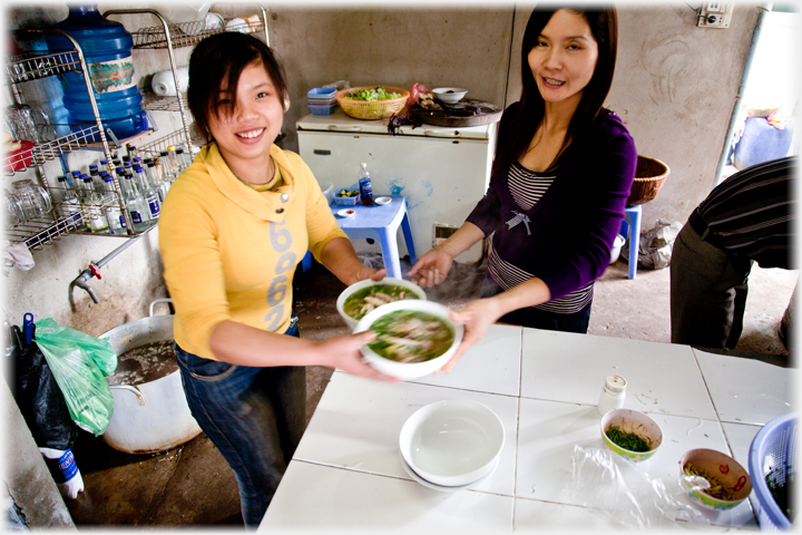 Serving pho with a smile.