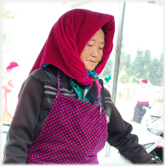 Woman in red headscarf.