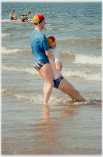 Life-saver dragging casulty out of the water walking backwards.