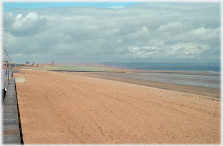 The sand looking west along the beach with the marks of the morning clean-up.