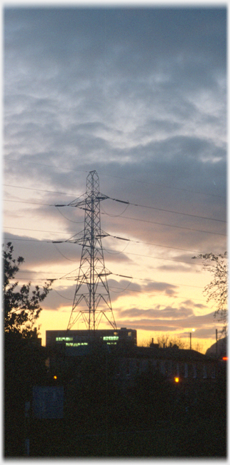 Sunset and pylon with secondary school lights showing.