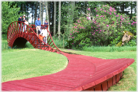 Wooden walkway leading to bridge.