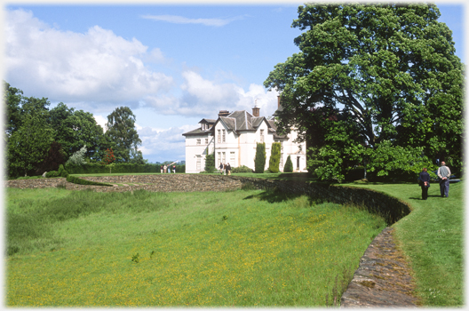 Portrack House with meadow in front.