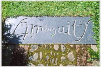 Paving stone with the word Ambiguity engraved made to be read form both sides.