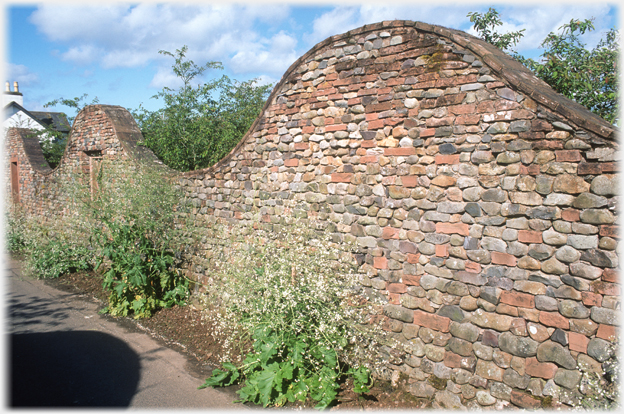 Section of undulating brick wall.