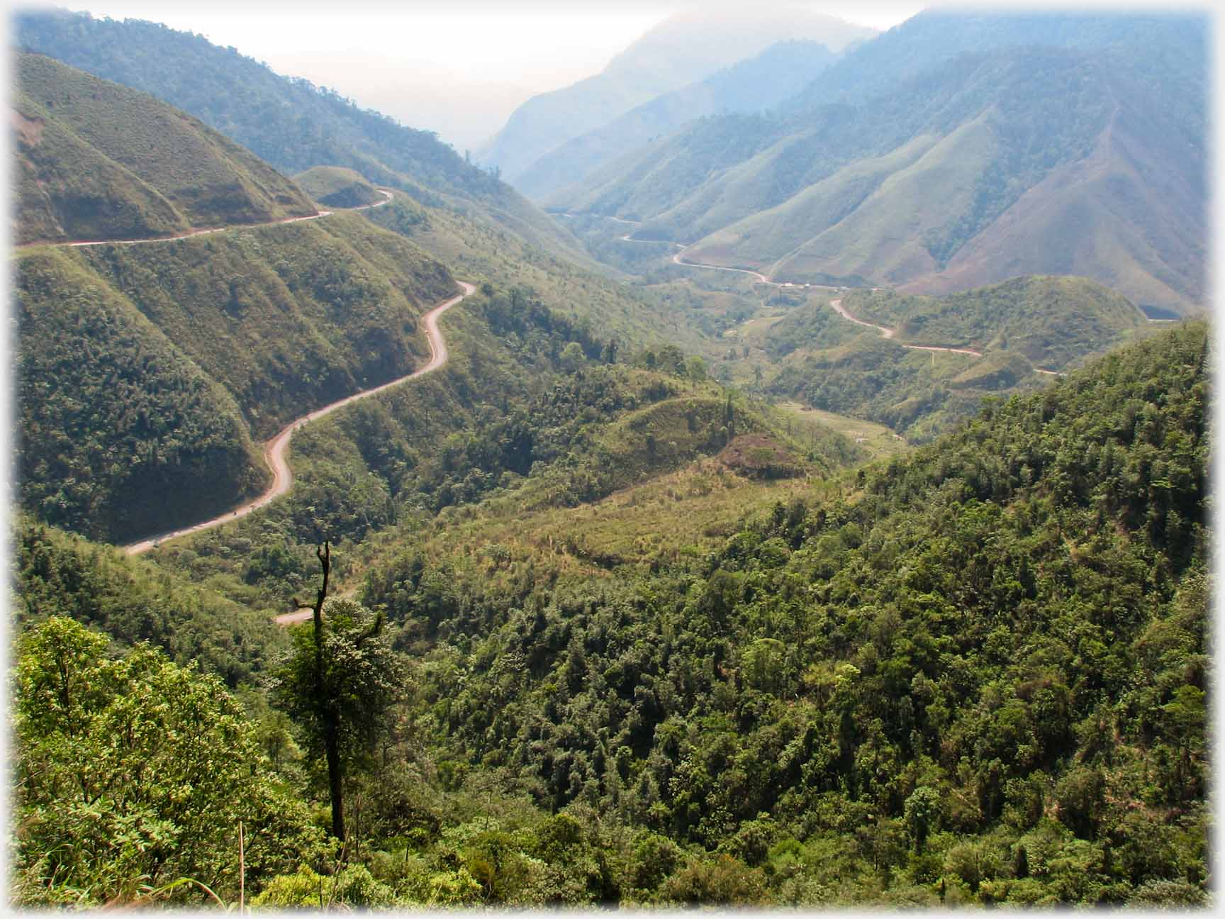 Long valley with three roads visible running to the distance.