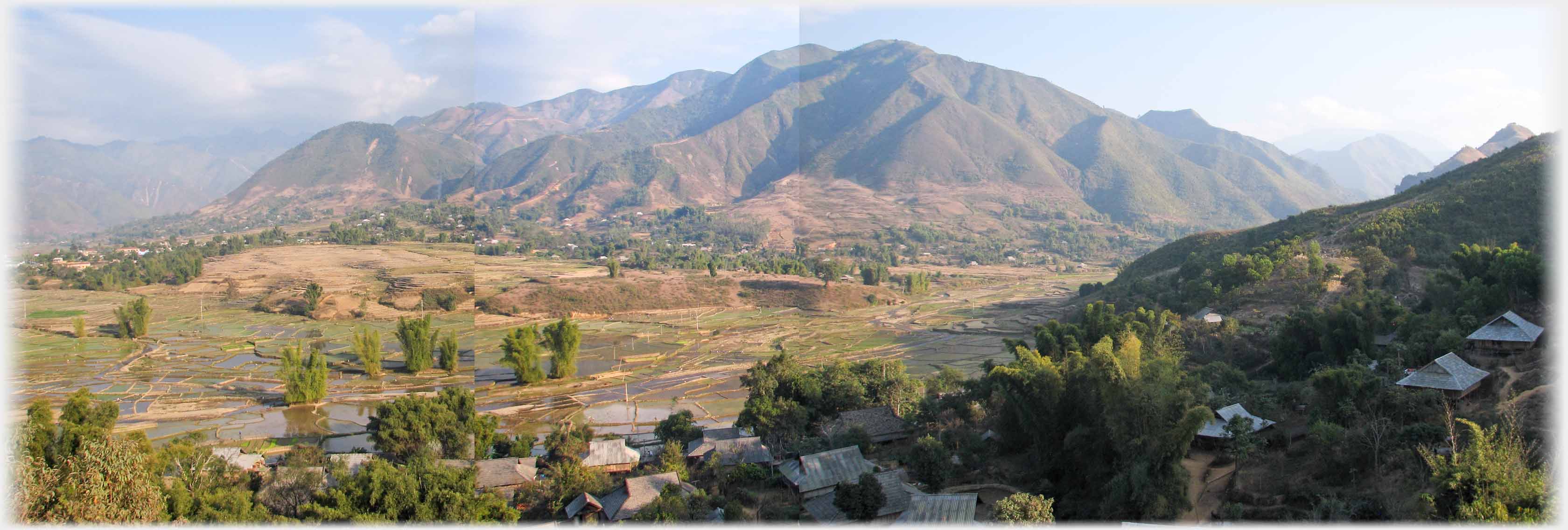 Mountain with valley and wooded community between.