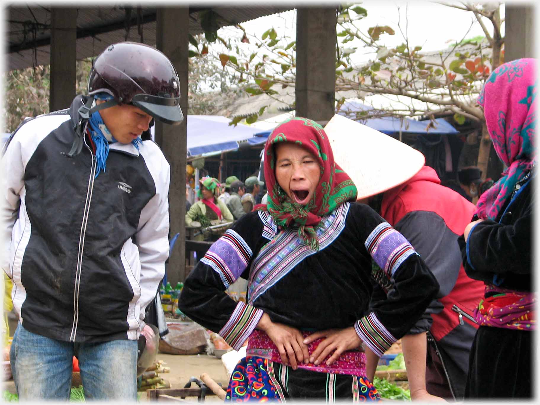 Woman looking down at smaller woman who is holding her waist mouth wide open.