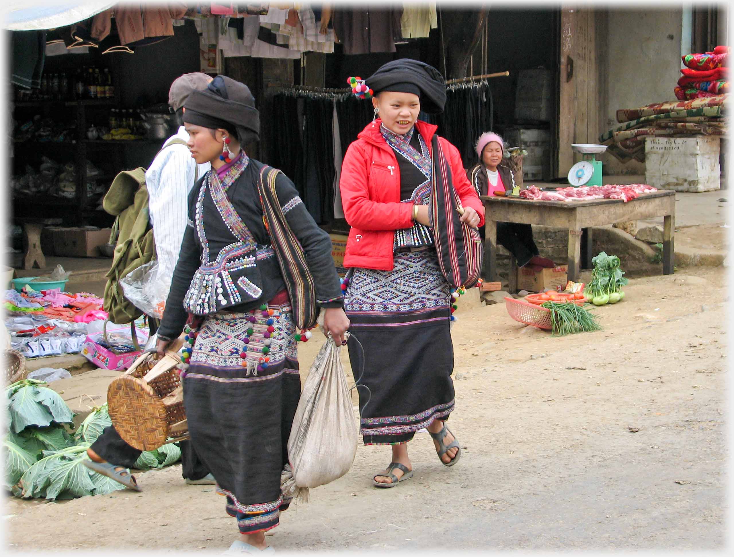 The last two women turning away from stalls.