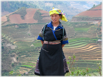 Woman staning with terraced fields as background.
