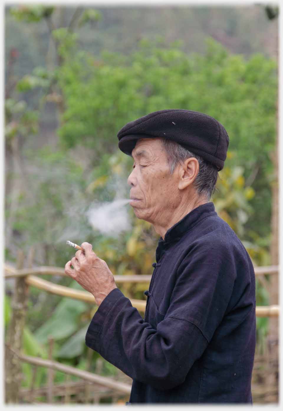 Older man wiht cigarette ex-hailing.
