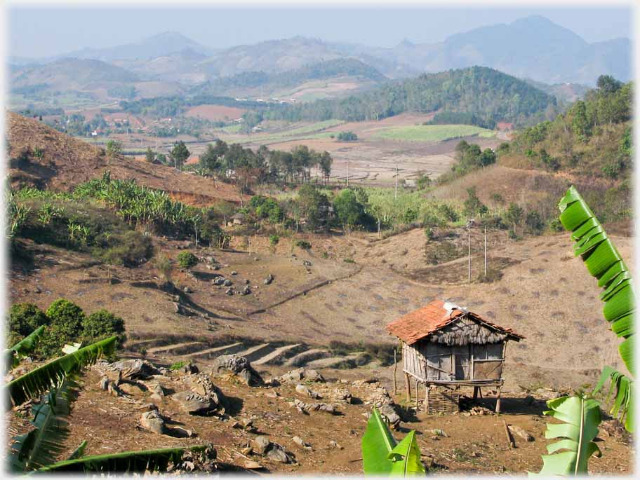 Stilted house looking down wide valley with distant hills