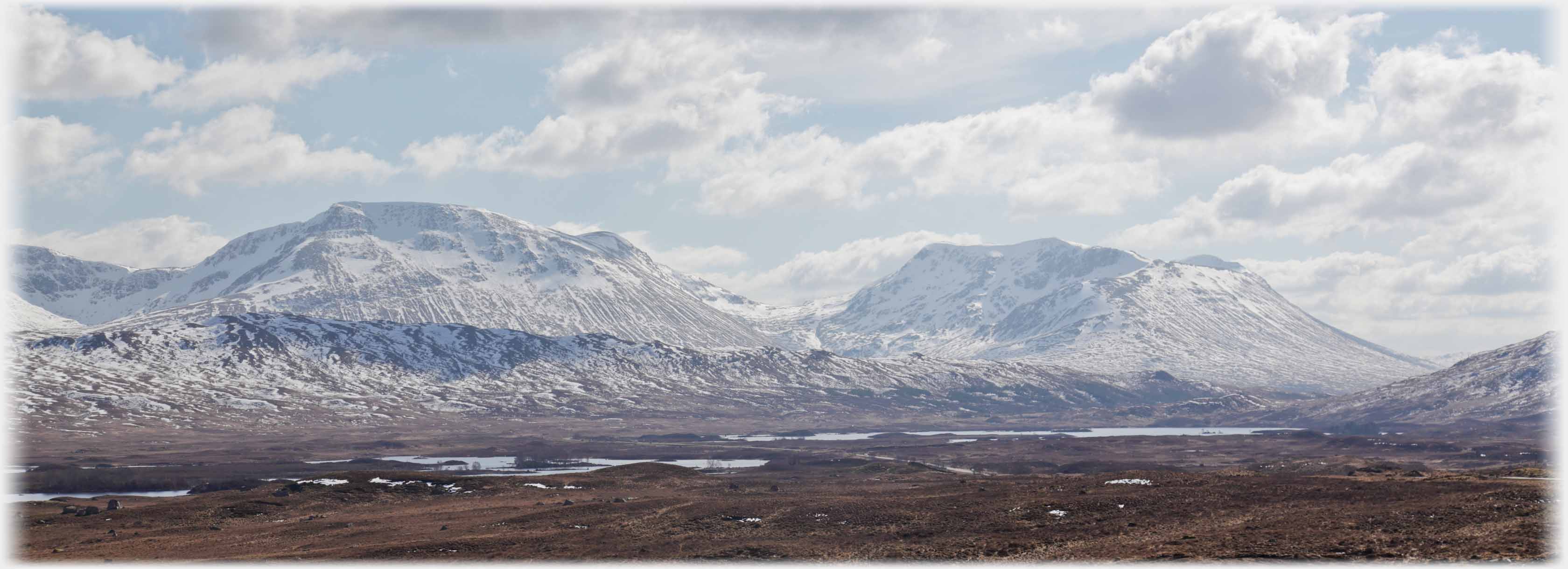 Across moorland to two hills sprinkled in white.