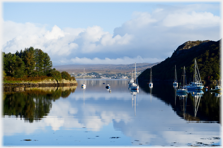 Bay with yachts moored in still water.