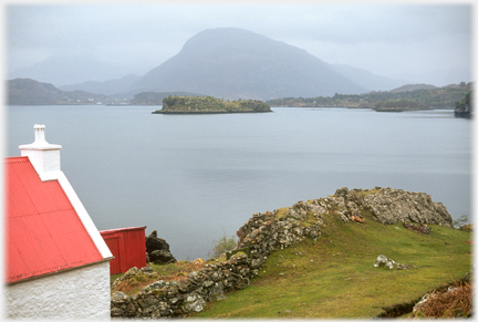 Red roofed house with hill an even grey.