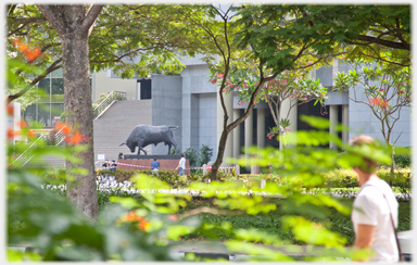 Bull statue amongst trees.