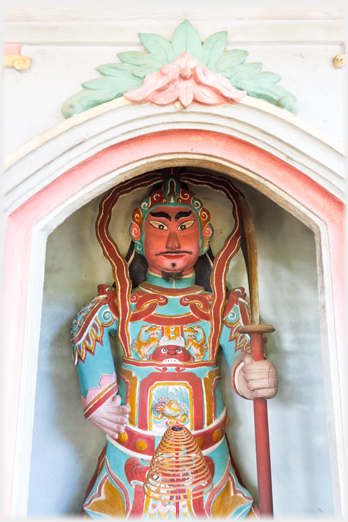 Guardian warrier with pike in niche.