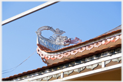 A dragon on the corner of the roof.