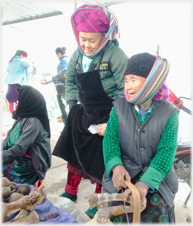 Two women in headscarfs in market.
